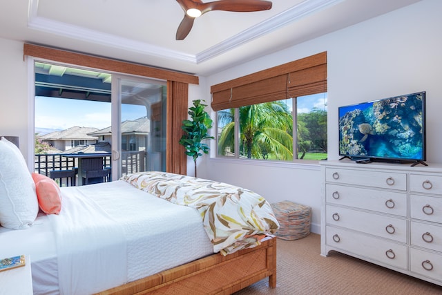 bedroom featuring crown molding, ceiling fan, a tray ceiling, access to outside, and light colored carpet