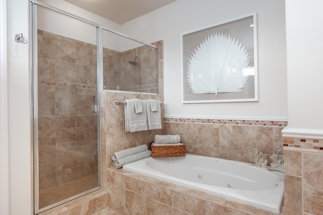 bathroom featuring separate shower and tub