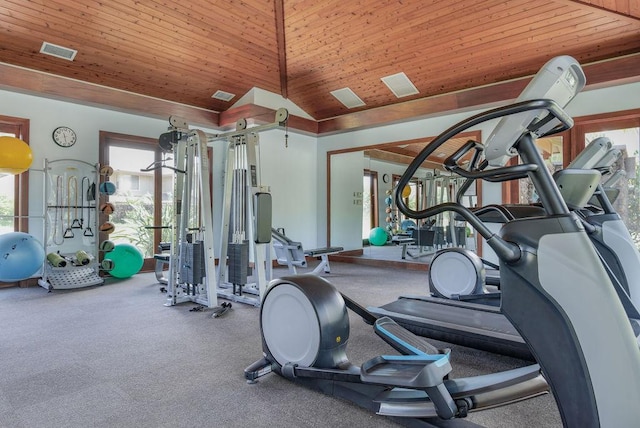 gym with a healthy amount of sunlight, a high ceiling, and wooden ceiling