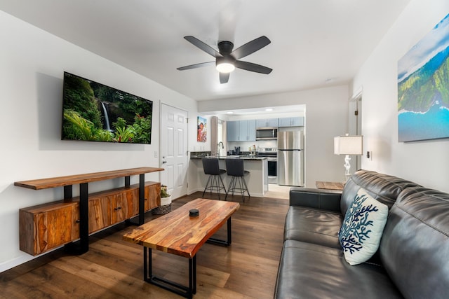 living room with dark hardwood / wood-style floors and ceiling fan