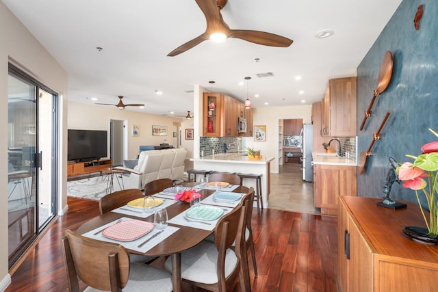 dining area with dark hardwood / wood-style flooring and sink