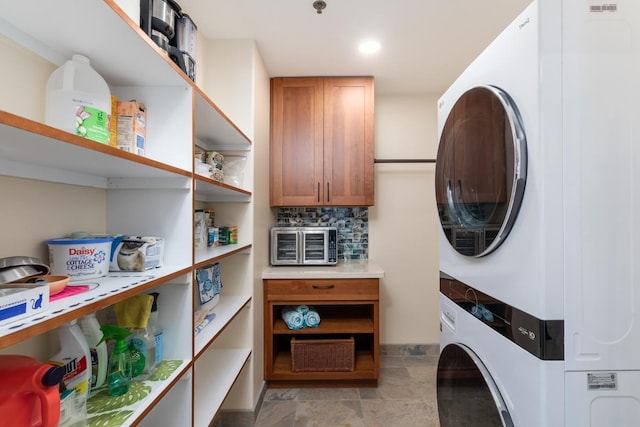 laundry room featuring stacked washer and clothes dryer