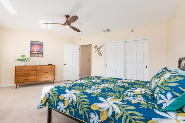 carpeted bedroom featuring ceiling fan and a closet