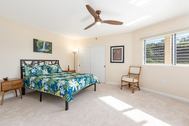 bedroom featuring light carpet, a closet, and ceiling fan