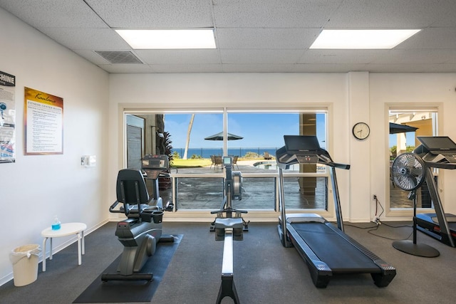 workout area with a paneled ceiling