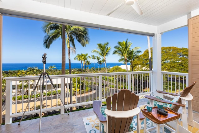 balcony with a water view and ceiling fan