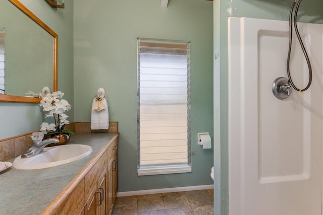 bathroom featuring walk in shower and vanity