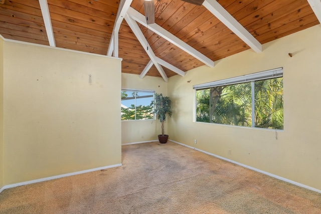 unfurnished room featuring vaulted ceiling with beams, wooden ceiling, and carpet