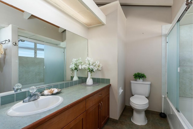 full bathroom featuring tile patterned flooring, enclosed tub / shower combo, vanity, and toilet