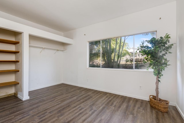 unfurnished bedroom with dark hardwood / wood-style flooring and a closet