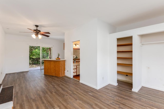 unfurnished living room with ceiling fan and dark hardwood / wood-style flooring