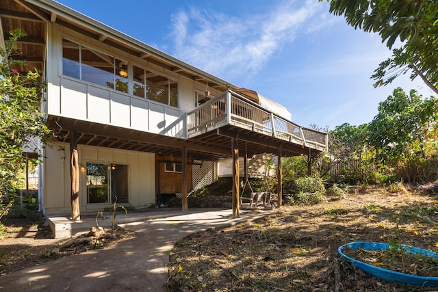 rear view of property featuring a deck and a patio