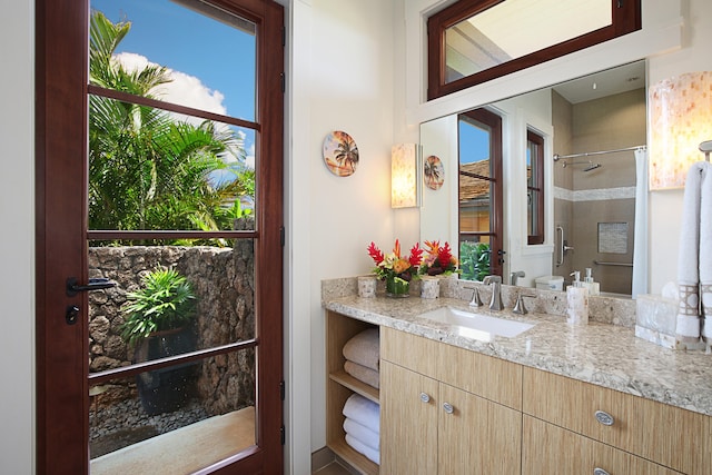 bathroom with vanity and a tile shower