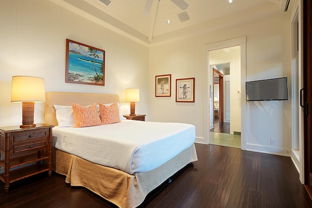 bedroom with ceiling fan, dark hardwood / wood-style flooring, and high vaulted ceiling