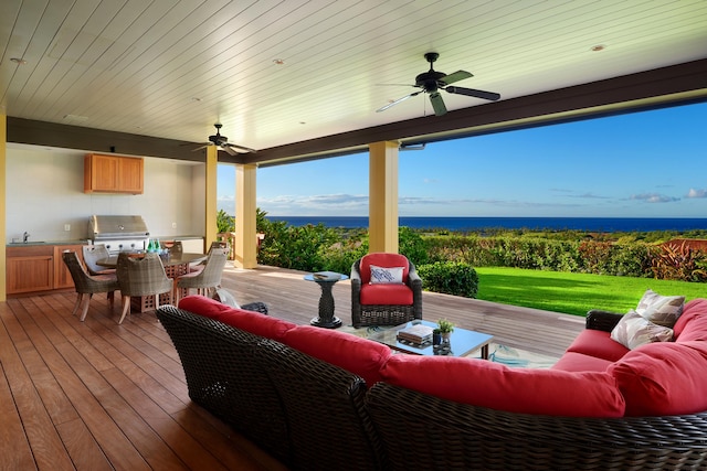 deck featuring ceiling fan, an outdoor hangout area, sink, and area for grilling