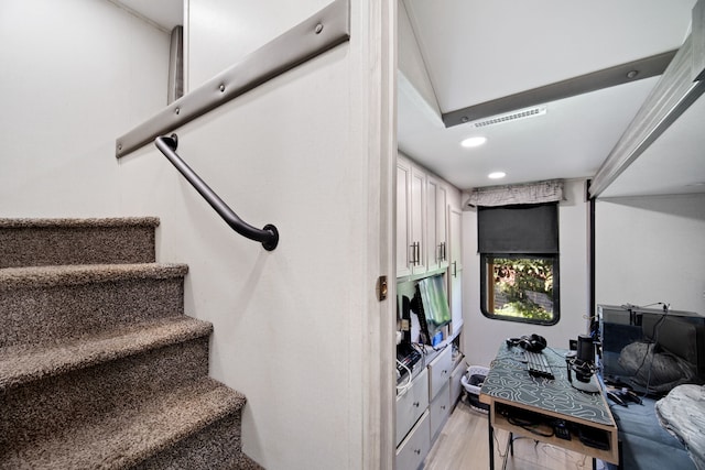 staircase with wood-type flooring