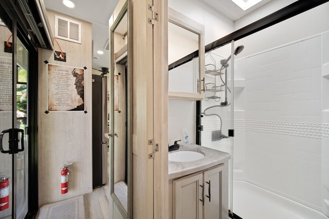 bathroom with vanity and walk in shower