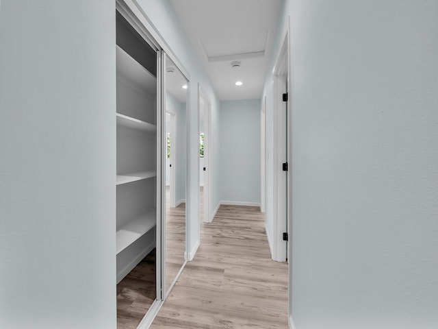 hallway with light hardwood / wood-style floors