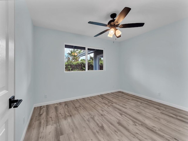 empty room with ceiling fan and light wood-type flooring