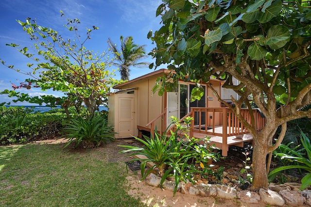 view of yard with a wooden deck and an outbuilding