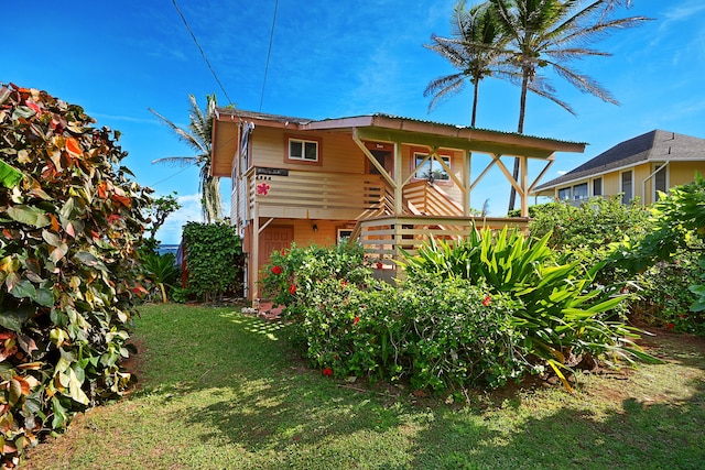 rear view of property featuring a yard