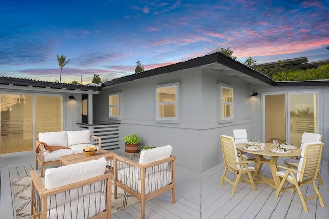 deck at dusk with an outdoor living space