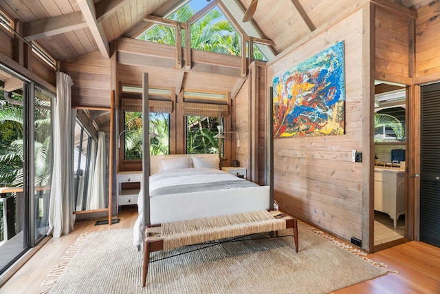 bedroom with wooden walls, wooden ceiling, light wood-type flooring, and access to exterior