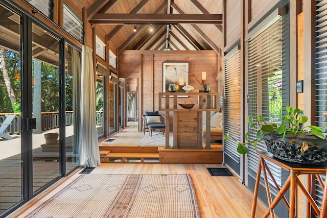 interior space featuring wood ceiling and vaulted ceiling with beams