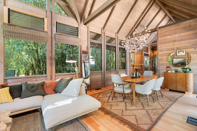 sunroom / solarium featuring wooden ceiling, a healthy amount of sunlight, a chandelier, and vaulted ceiling with beams