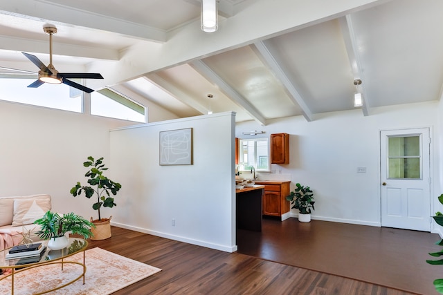 sitting room with dark wood-type flooring, ceiling fan, and lofted ceiling with beams