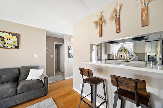 kitchen featuring light hardwood / wood-style flooring and stainless steel refrigerator with ice dispenser