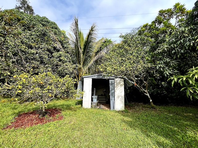 view of outbuilding with a lawn