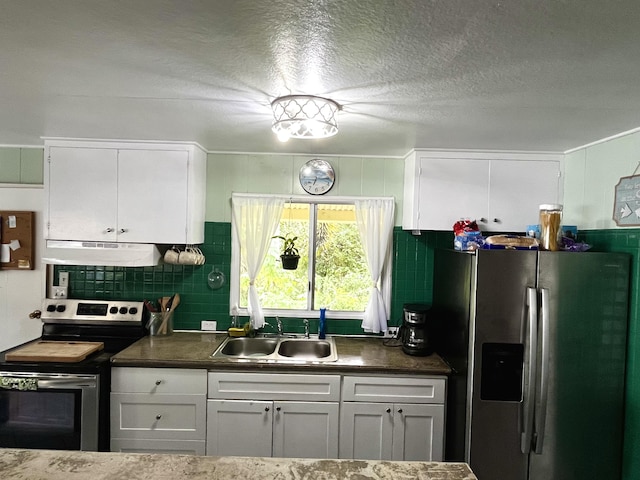 kitchen with appliances with stainless steel finishes, sink, and white cabinets