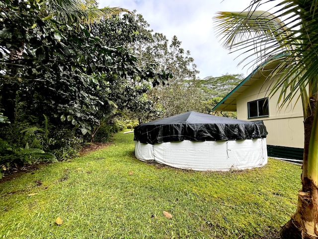 view of yard featuring a covered pool