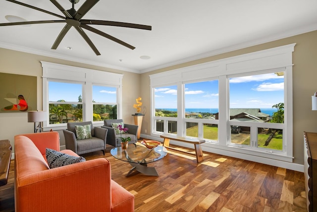 living room with crown molding, wood-type flooring, and ceiling fan