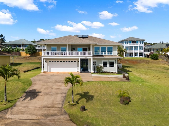 view of front facade with solar panels, a balcony, a garage, and a front lawn