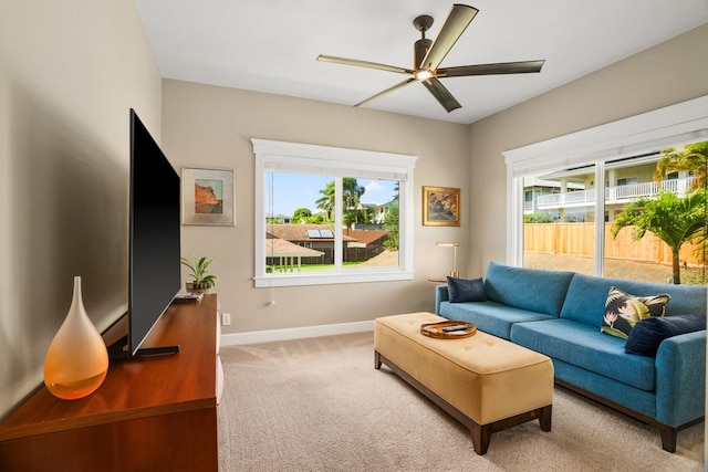 carpeted living room featuring ceiling fan