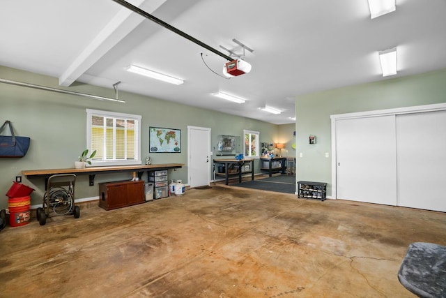 garage featuring a garage door opener and a workshop area