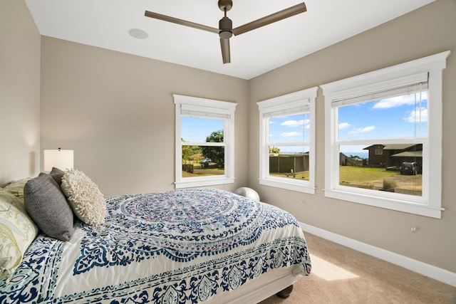 bedroom with light carpet and ceiling fan