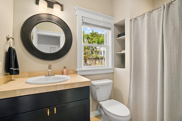 bathroom featuring a shower with curtain, vanity, and toilet