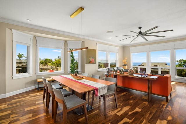 dining area featuring dark wood-type flooring, ornamental molding, and ceiling fan