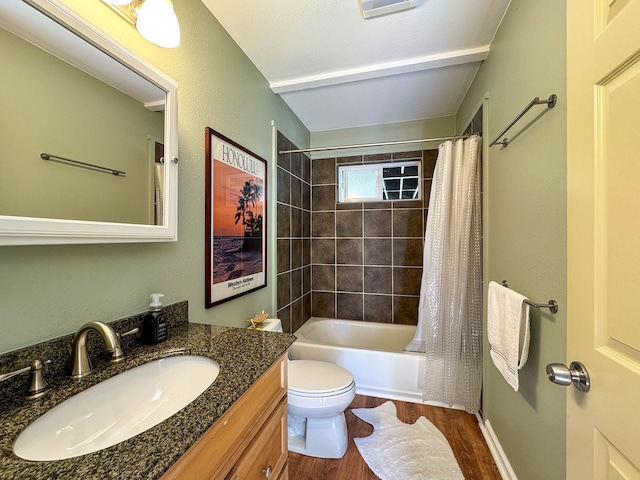 full bathroom featuring hardwood / wood-style flooring, shower / tub combo with curtain, vanity, and toilet