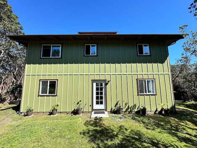 rear view of property with a yard