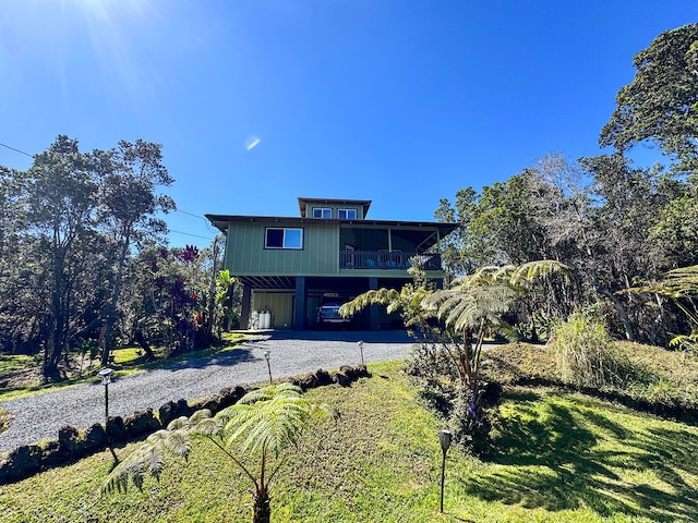 view of front of house featuring a carport and a balcony