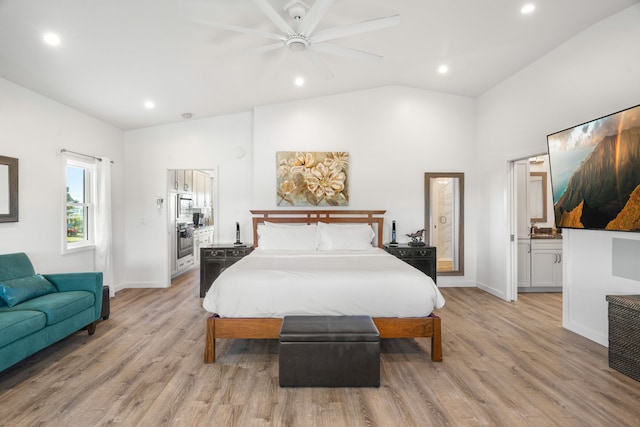 bedroom with ceiling fan, vaulted ceiling, and light hardwood / wood-style flooring