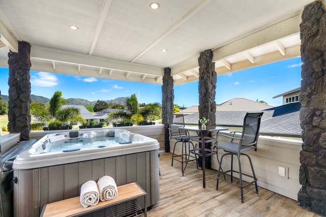 wooden terrace with a hot tub