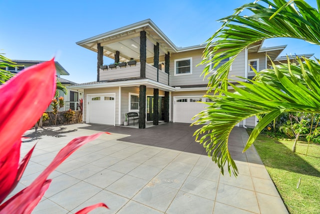 view of front facade with a balcony and a garage