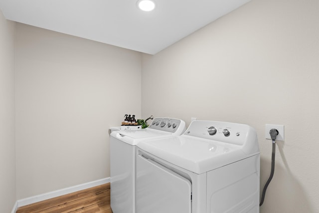 laundry area featuring light wood-type flooring and independent washer and dryer