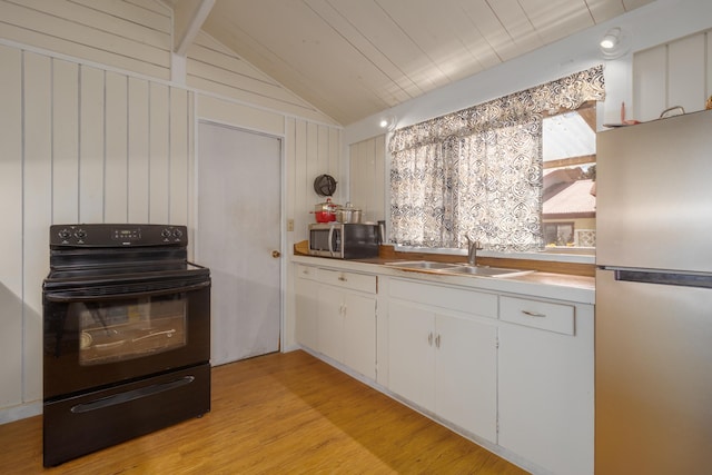 kitchen with white cabinetry, lofted ceiling, sink, light hardwood / wood-style floors, and stainless steel appliances