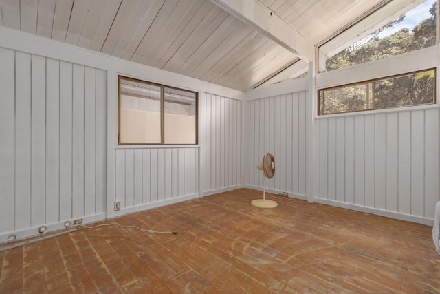 unfurnished room featuring lofted ceiling with beams